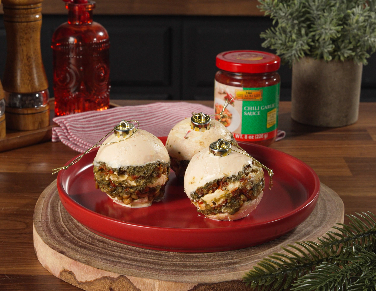 A pesto cheese ball ornament recipe for Christmas made with Lee Kum Kee Chili Garlic Sauce.