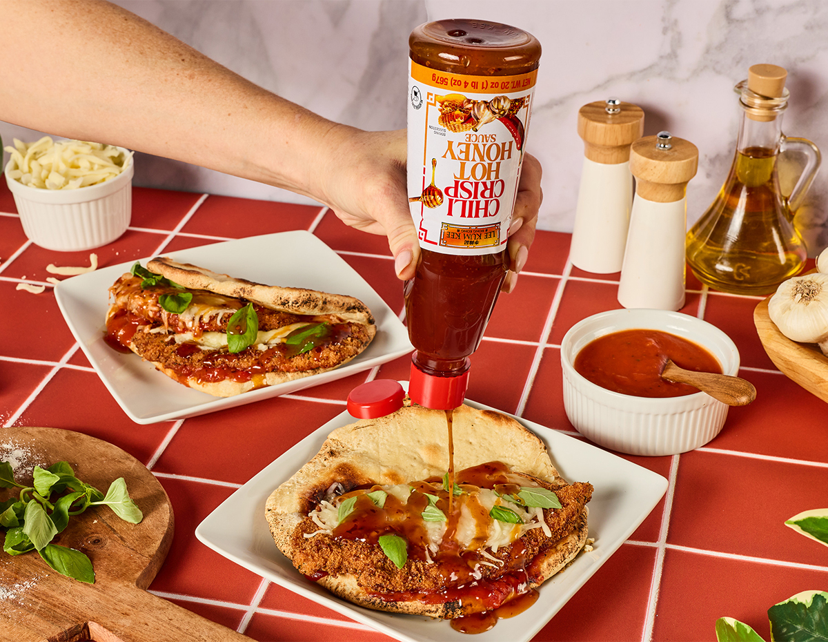 A pizza sandwich recipe filled with chicken parm and topped with chili crisp hot honey.