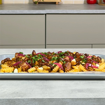 A poutine recipe topped with hoisin marinated pork belly.
