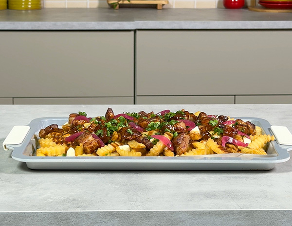 A poutine recipe topped with hoisin marinated pork belly.