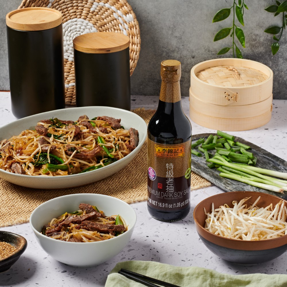 A plate of beef chow fun, made with Lee Kum Kee Premium Dark Soy Sauce for color.