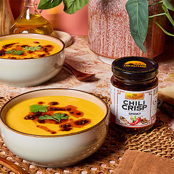 A creamy pumpkin soup recipe drizzled with smoky Lee Kum Kee chili crisp for garnish.