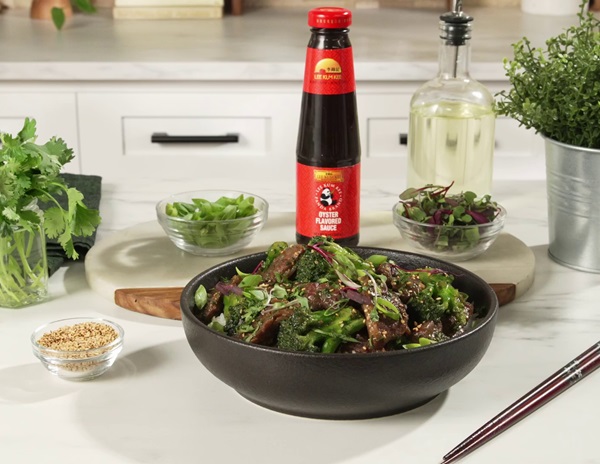 Prepared beef and broccoli stir-fry from Lee Kum Kee’s recipe accompanied by Lee Kum Kee Panda Brand Oyster Flavored Sauce