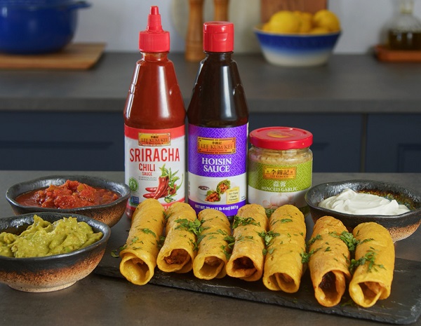 Easy Crispy chicken taquito recipe made on a serving platter, alongside dipping sauces and the Lee Kum Kee sauces used in the dish.
