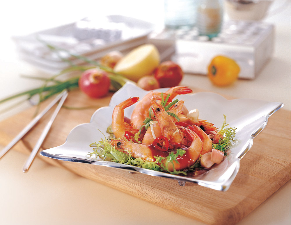 Fried Prawns with Oyster-Flavored Sauce served on a fancy plate on a wooden board