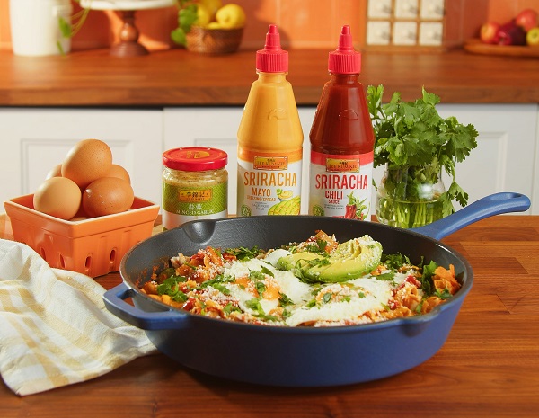 Easy chilaquiles served from the skillet they were prepared in, alongside the Lee Kum Kee sauces and ingredients used in the dish