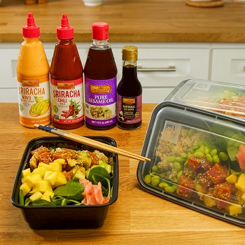 Prepared poke meal prep bowls and Lee Kum Kee sauces