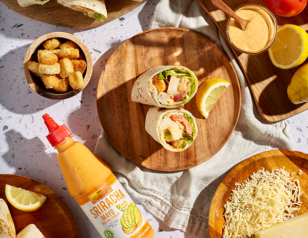 A Spicy Chicken Caesar Wrap surrounded by ingredients