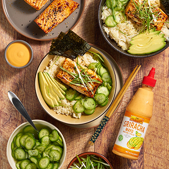 Servings of sriracha mayo salmon in bowls alongside Lee Kum Kee sauce
