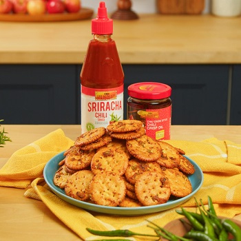 Sweet and spicy cracker bite recipe made on a serving plate, alongside the Lee Kum Kee sauces used in the dish