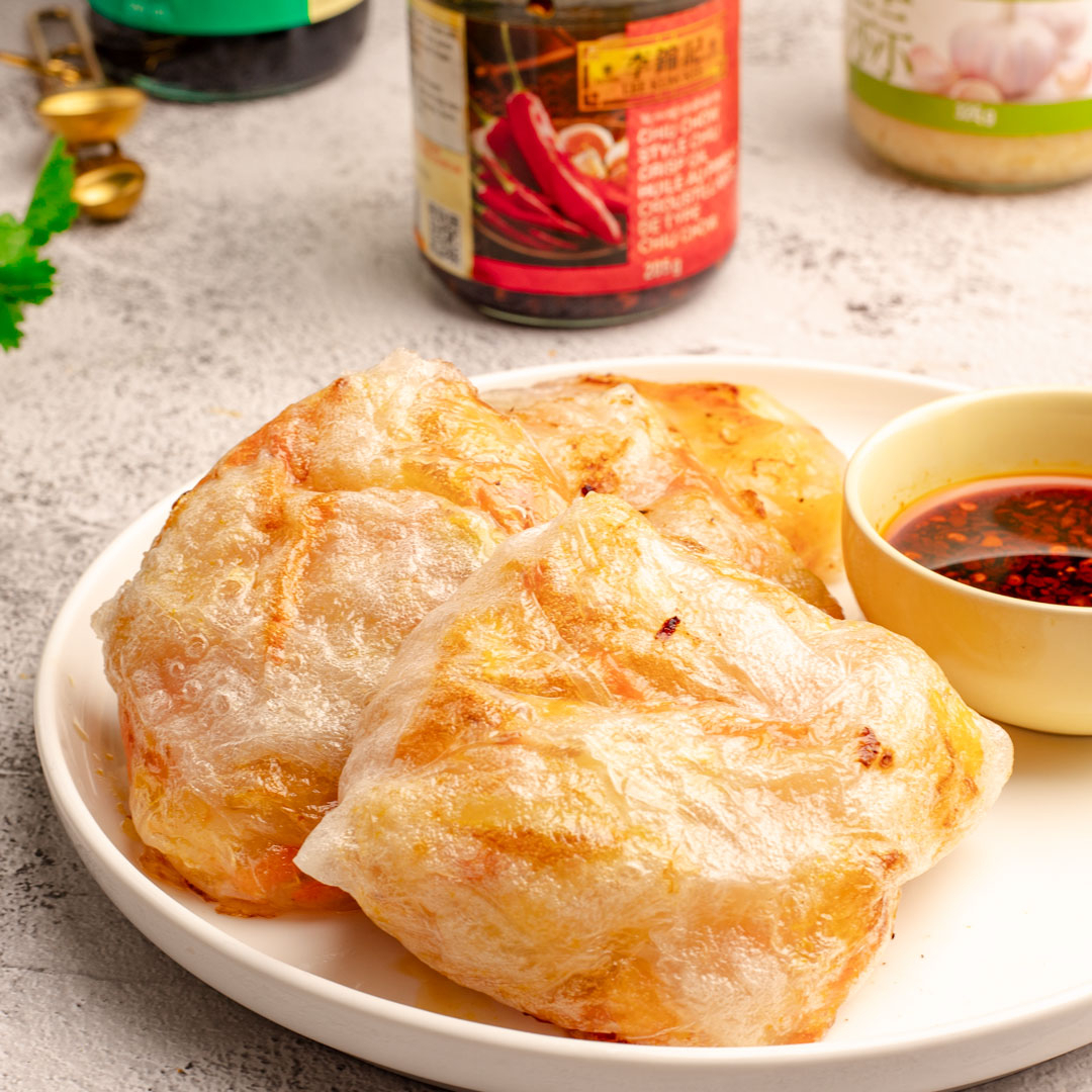 An air fryer crispy rice paper dumplings recipe filled with prawns and served with Lee Kum Kee sauces.