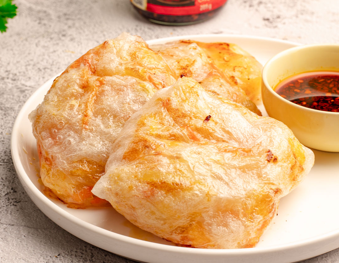 An air fryer crispy rice paper dumplings recipe filled with prawns and served with Lee Kum Kee sauces.