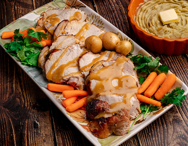 A roasted turkey breast recipe served with a honey soy glaze and gravy.