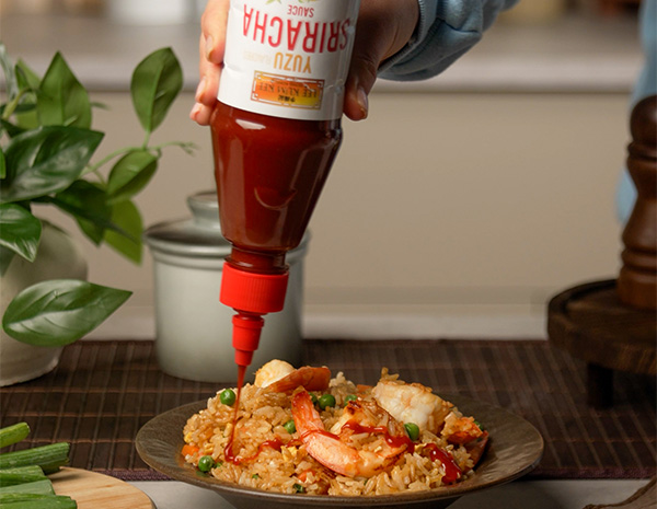 A shrimp fried rice recipe topped with Yuzu Sriracha Sauce.