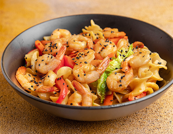 A shrimp stir fry recipe with oyster sauce over egg noodles.