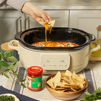 A slow cooker recipe for chorizo queso made with chili garlic sauce.
