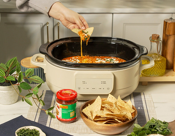 A slow cooker recipe for chorizo queso made with chili garlic sauce.