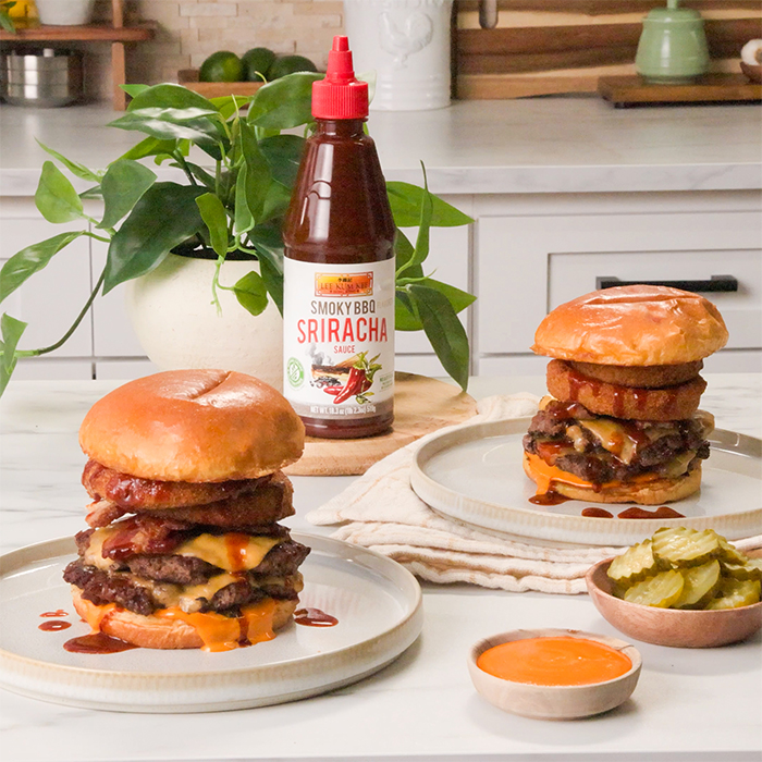 A smoky BBQ smashburger recipe with bacon, crispy onions, sriracha mayo, and smoky bbq sriracha sauce.
