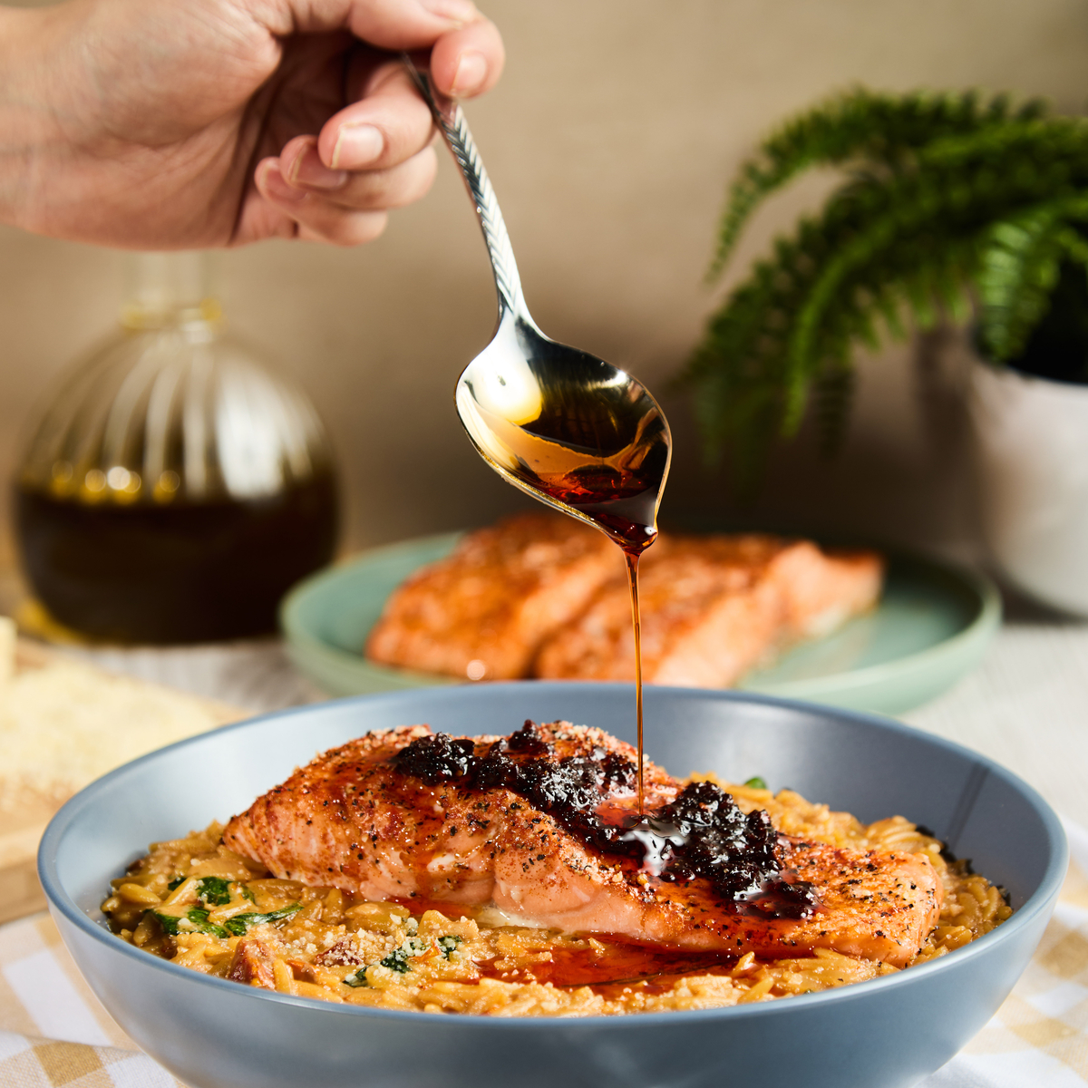 A spicy creamy Tuscan salmon recipe with orzo and Lee Kum Kee chili crisp.