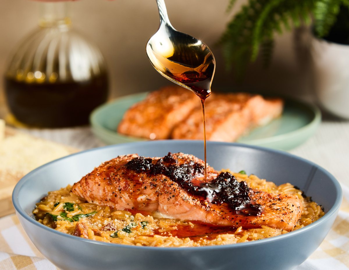 A spicy creamy Tuscan salmon recipe with orzo and Lee Kum Kee chili crisp.