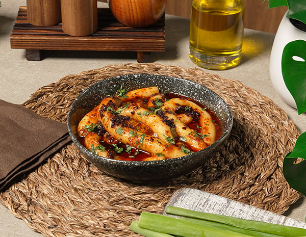 A spicy potato noodles recipe served with a flavorful chili sauce.