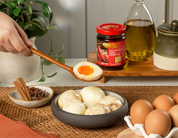 A spicy tea eggs recipe for a spicy twist on soy marinated eggs made with chili crisp oil.