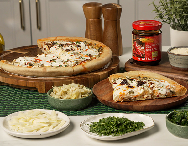 A spinach artichoke pizza recipe made with the cast iron pan pizza method.