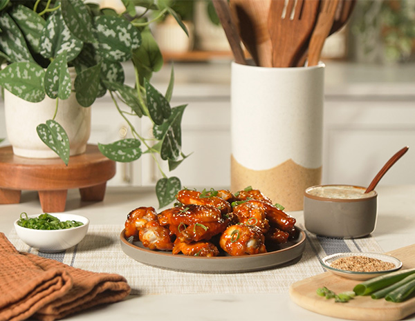 A sweet and spicy wings recipe made with a Gochujang Honey Sriracha glaze.