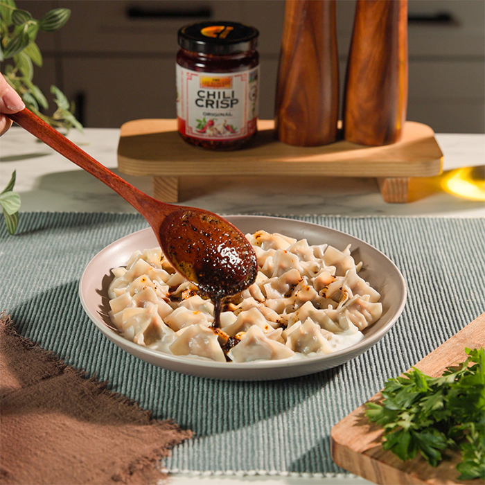 A Turkish style manti recipe topped with a chili crisp butter sauce.