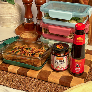 An udon meal prep recipe made with oyster sauce and topped with chili crisp.