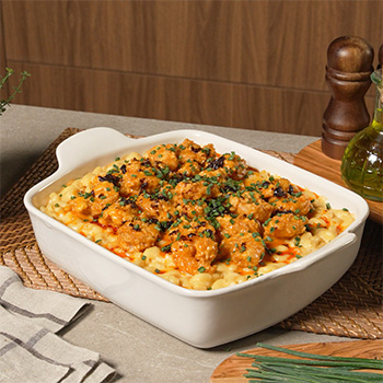 A bang bang shrimp recipe served on top of mac and cheese.