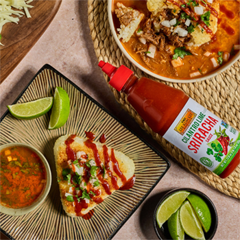 A yaki onigiri recipe stuffed with leftover birria and Oaxaca cheese, served with consommé and Cilantro Lime flavored Sriracha.