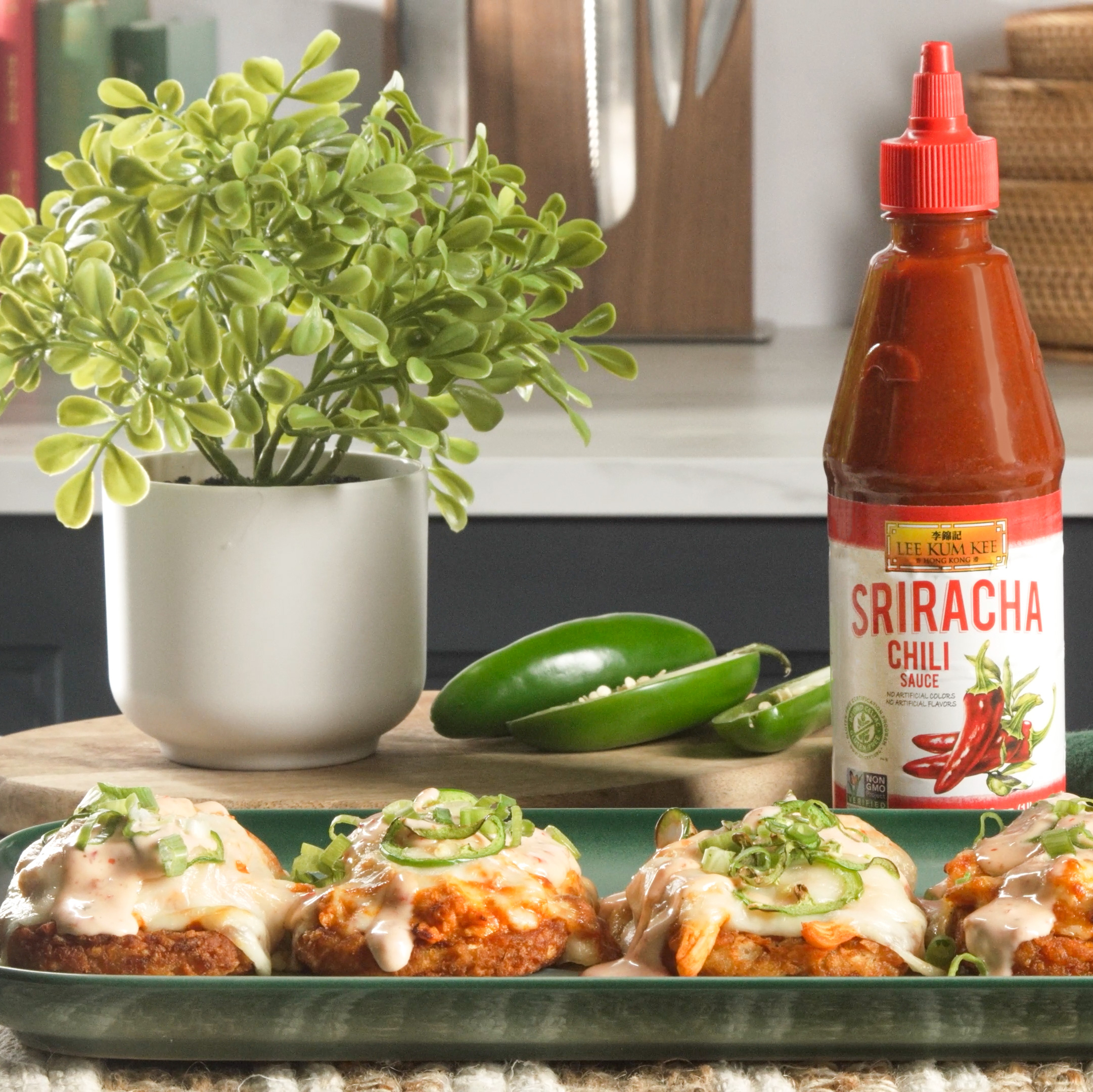 Prepared Buffalo chicken hashbrown potatoes on a serving platter, alongside the Lee Kum Kee Sriracha Chili Sauce used to make them