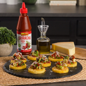Cheesy Polenta Bites topped with spicy brussels sprouts, made with Lee Kum Kee Sriracha Chili Sauce for heat.
