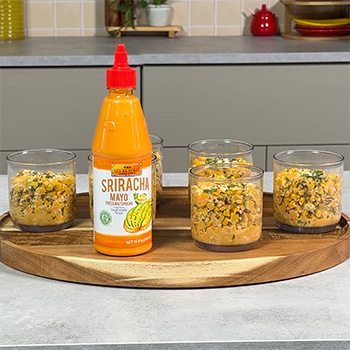 A recipe for esquites, a Mexican street corn recipe made with sriracha mayo and served in cups.