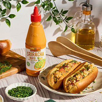 A lobster roll recipe made with a dill pickle remoulade, using a base of Sriracha Mayo.