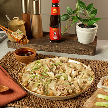 An easy no fold dumplings recipe for pork dumplings, flavored with oyster sauce, and a soy-chili crisp dipping sauce.