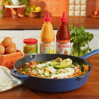 Easy chilaquiles served from the skillet they were prepared in, alongside the Lee Kum Kee sauces and ingredients used in the dish