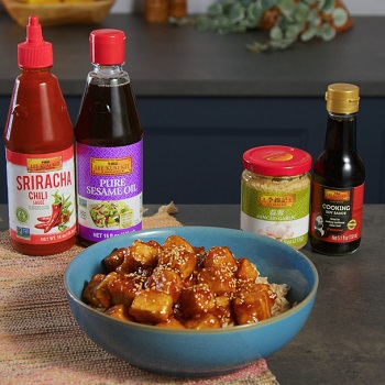 Sesame tofu recipe in a bowl, alongside the Lee Kum Kee sauces used in the dish
