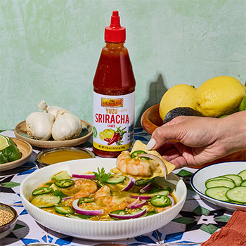 A shrimp aguachile recipe with cucumber and red onion, made with Yuzu sriracha sauce.