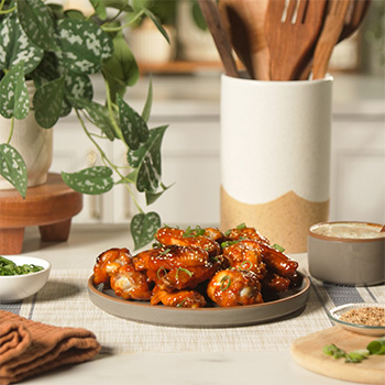 A sweet and spicy wings recipe made with a Gochujang Honey Sriracha glaze.